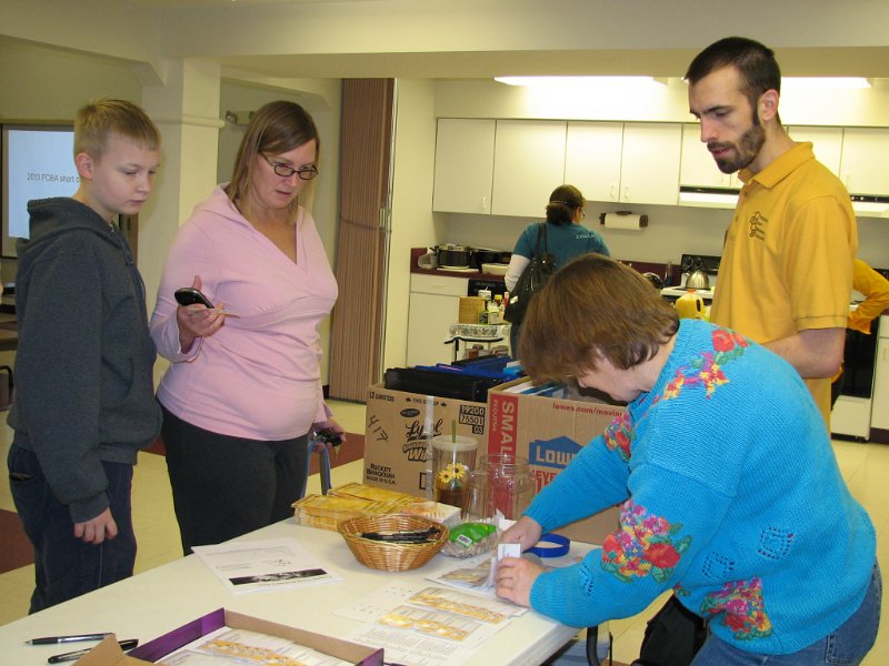 beecourse_day1 007.JPG - Liz registers two students, Mom and Son, as Kenny looks on.